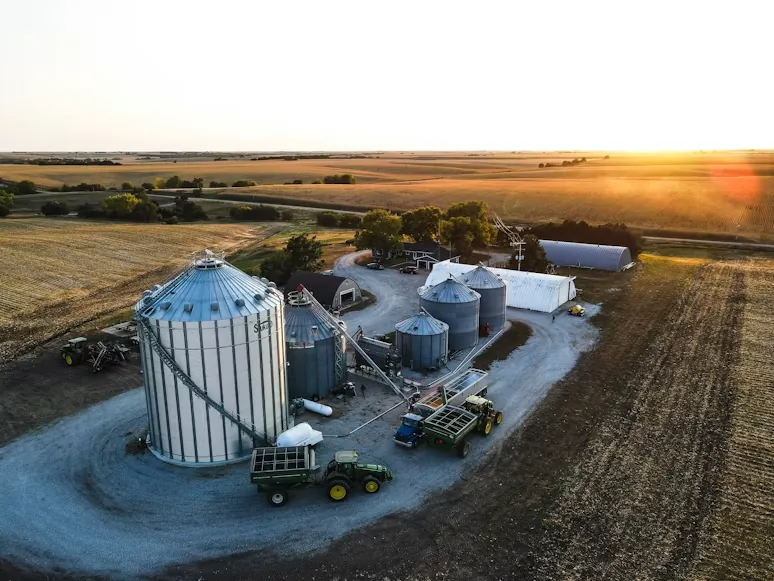 Aerial view of a farm with grain silos and cold storage at sunset
